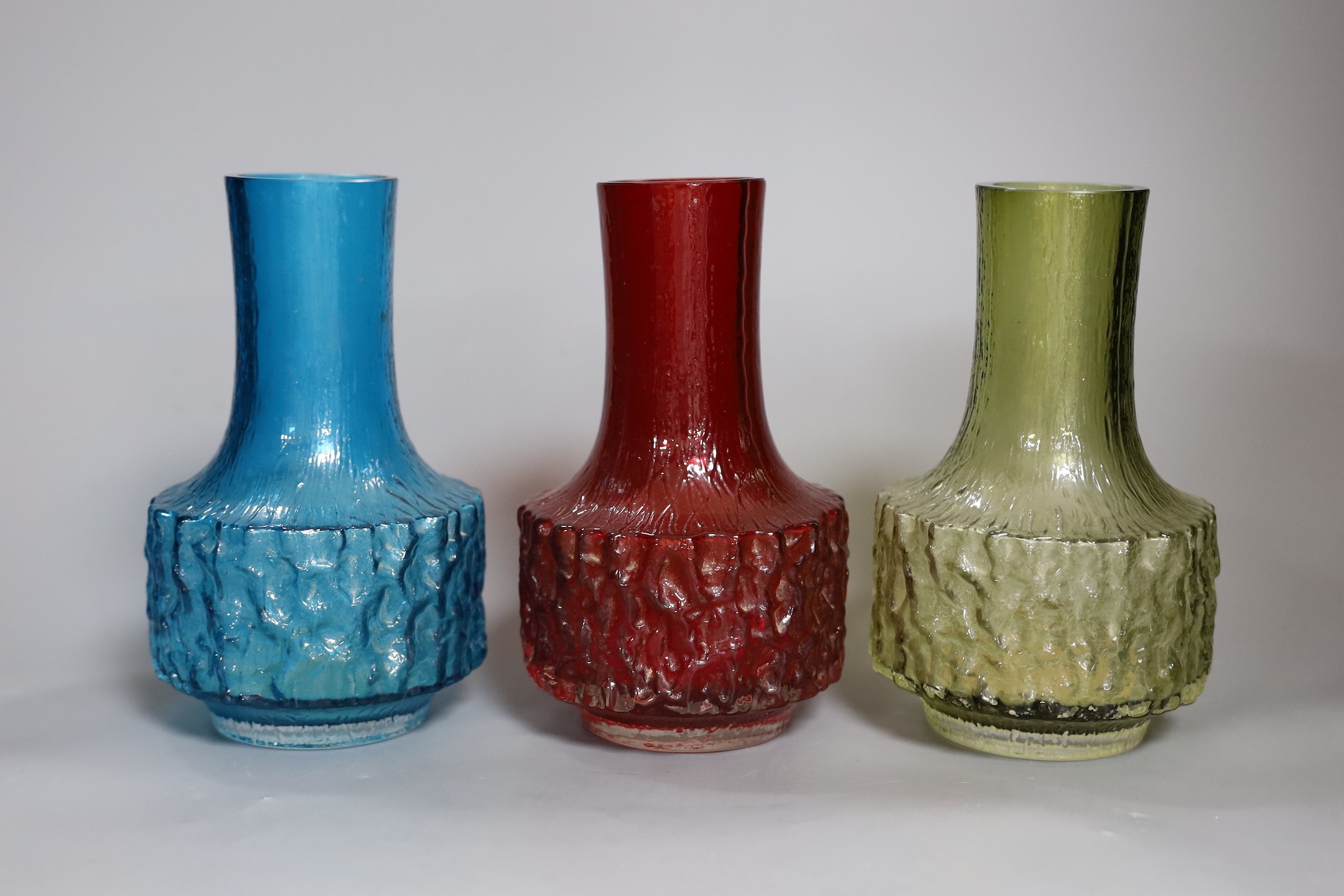 Three Whitefriars cylindrical bottle vases, in red, kingfisher blue and sage green glass (3) each 18cm high.